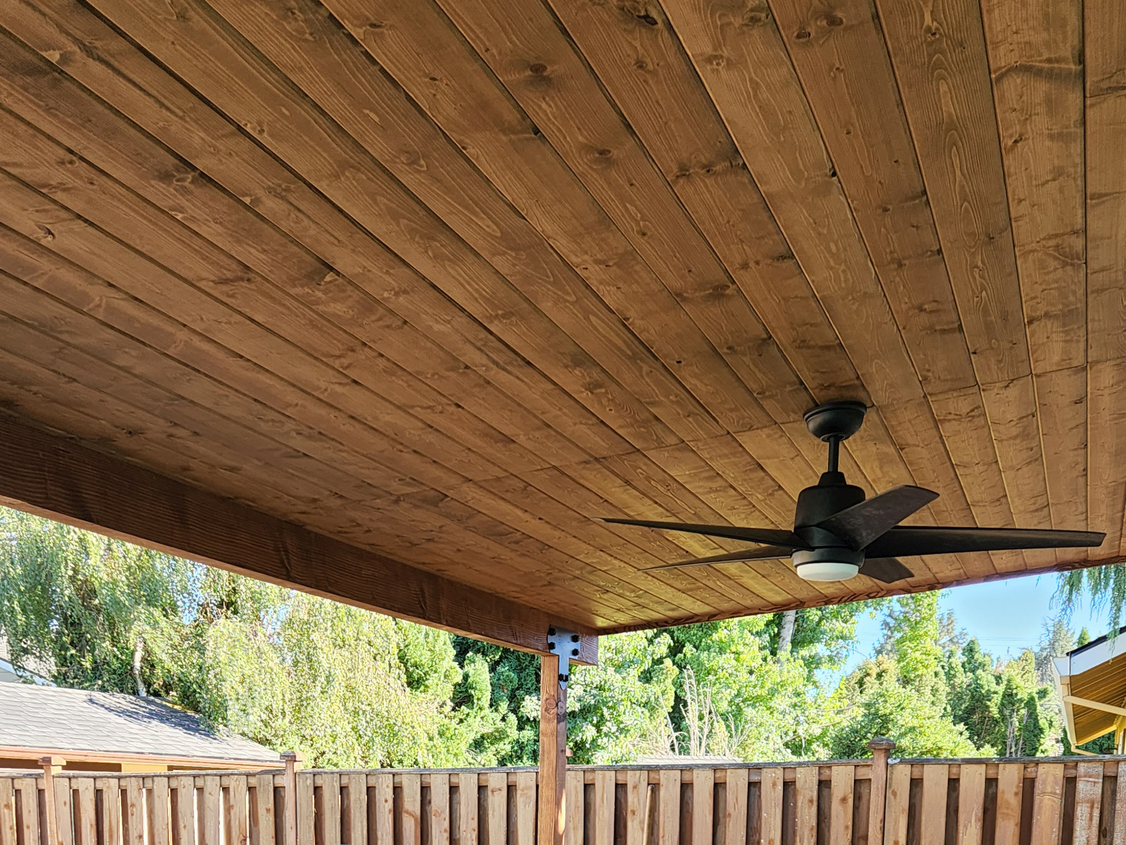 Covered patio roof with fan built by Casa Bella Construction